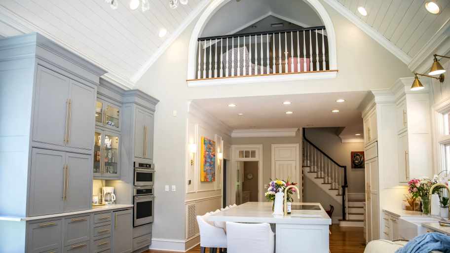 pen concept kitchen and living room with kitchen island, upper loft, and shiplap ceiling